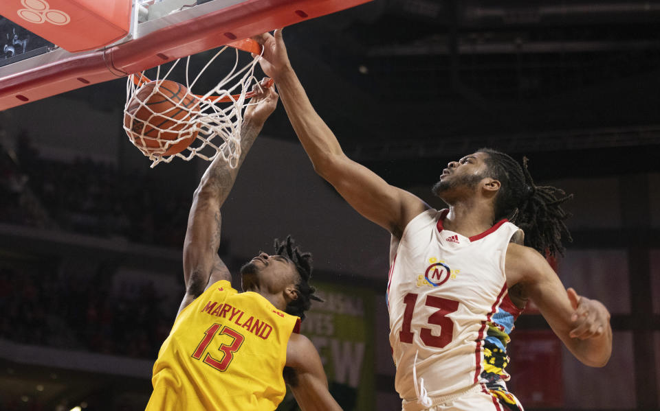 Maryland's Hakim Hart, left, dunks against Nebraska's Derrick Walker during overtime of an NCAA college basketball game Sunday, Feb. 19, 2023, in Lincoln, Neb. (AP Photo/Rebecca S. Gratz)