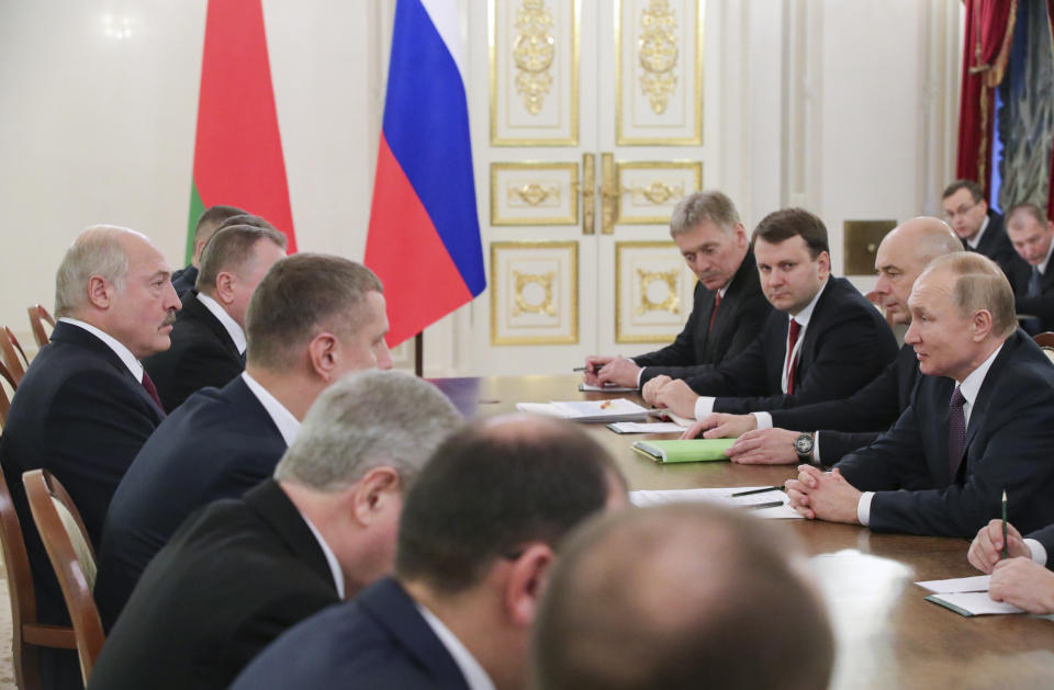 Russian President Vladimir Putin, right, talks to Belarusian President Alexander Lukashenko, left, during a meeting in St. Petersburg, Russia, Friday, Dec. 20, 2019. The presidents of Russia and Belarus are holding talks on expanding ties between the two ex-Soviet neighbors and allies. (Mikhail Klimentyev, Sputnik, Kremlin Pool Photo via AP)