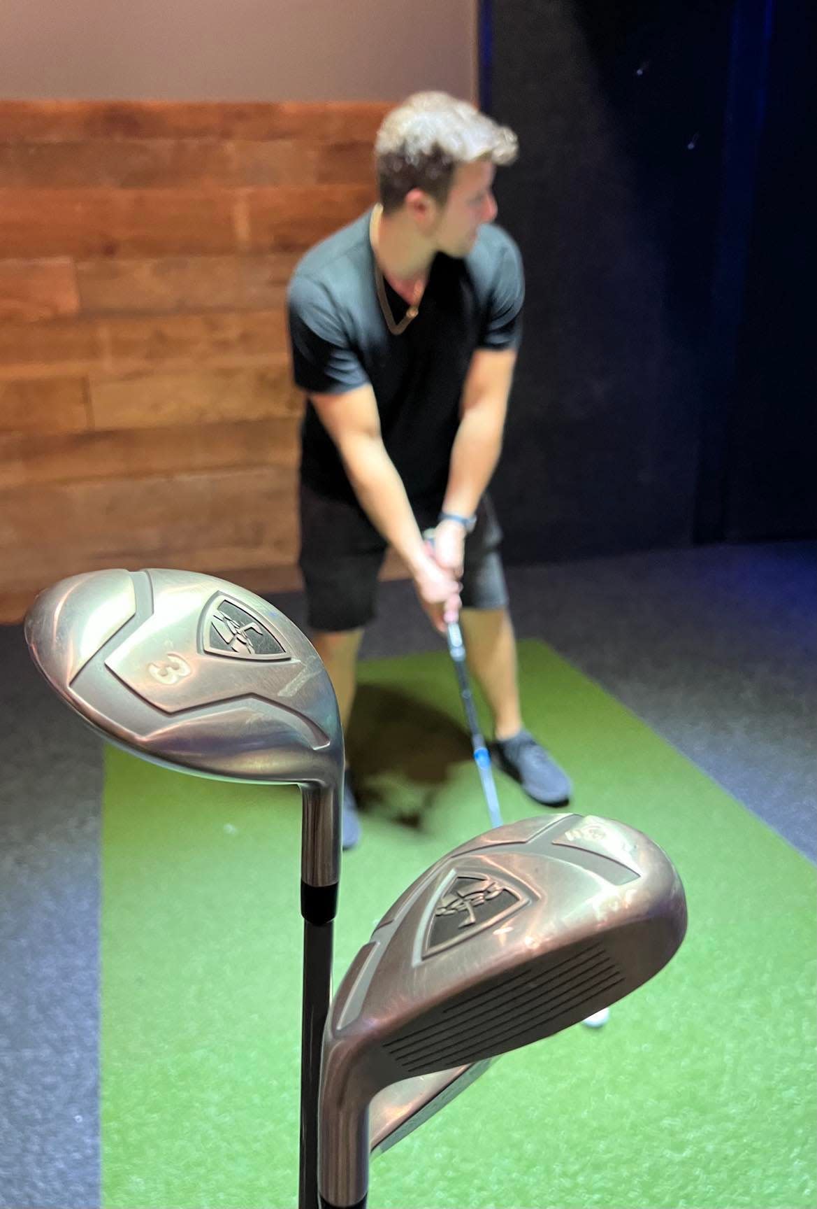 Vinnie Iannone, 28, of New Jersey, plays simulated golf recently at the Topgolf Swing Suite at The Brew Kettle at the Hall of Fame Village in Canton.