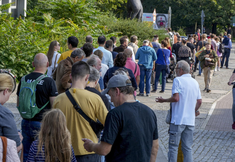 FILE --People queue in front of a polling station in the Moabit district of Berlin, Germany, Sept. 26, 2021. The city of Berlin on Sunday, Feb. 12, 2023, holds a court-ordered rerun of a chaotic 2021 state election that was marred by severe glitches at many polling stations. (AP Photo/Michael Probst, File)