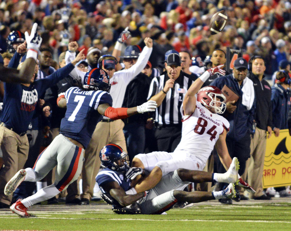 `Nov 7, 2015; Oxford, MS, USA; Arkansas Razorbacks tight end Hunter Henry (84) laterals the ball as he is tackled by Mississippi Rebels defensive back Tony Bridges (1) during overtime at Vaught-Hemingway Stadium. Arkansas won 53-52. Mandatory Credit: Matt Bush-USA TODAY Sports