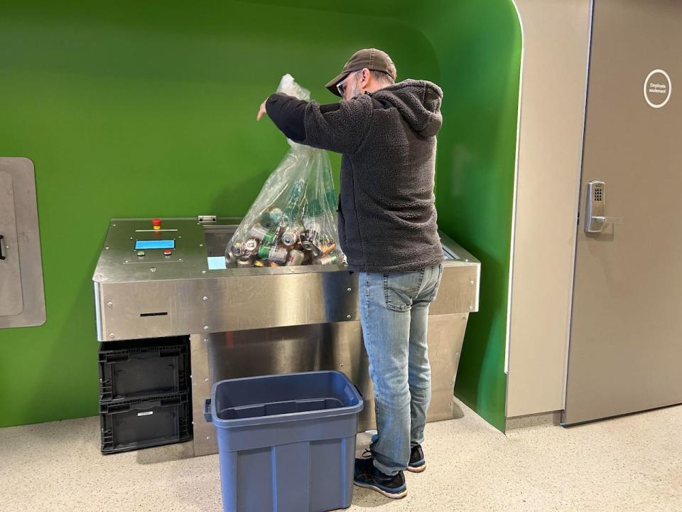 A user recycles his containers at the Consignaction deposit centre in Granby, Que. 