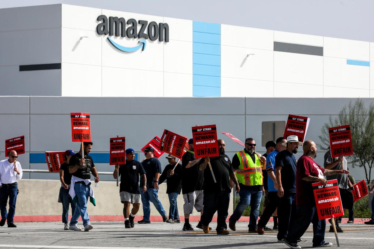 <span>Amazon warehouse workers and Teamsters union members protest Amazon’s unfair labor practices and call for an end to retaliation in San Bernardino, California, on 14 October 2022.</span><span>Photograph: Irfan Khan/Los Angeles Times/Getty Images</span>
