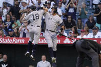 New York Yankees' Andrew Benintendi, left, is congratulated by Aaron Judge after hitting a solo home run during the first inning of a baseball game against the Los Angeles Angels Tuesday, Aug. 30, 2022, in Anaheim, Calif. (AP Photo/Mark J. Terrill)