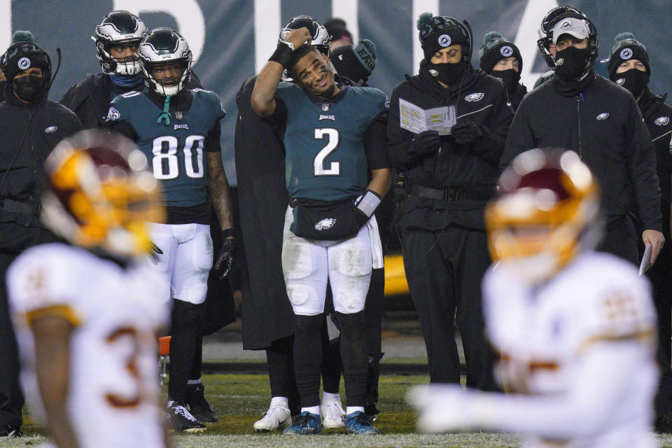 Philadelphia Eagles' Jalen Hurts scratches his head on the sideline during the second half against the Washington Football Team. (AP)