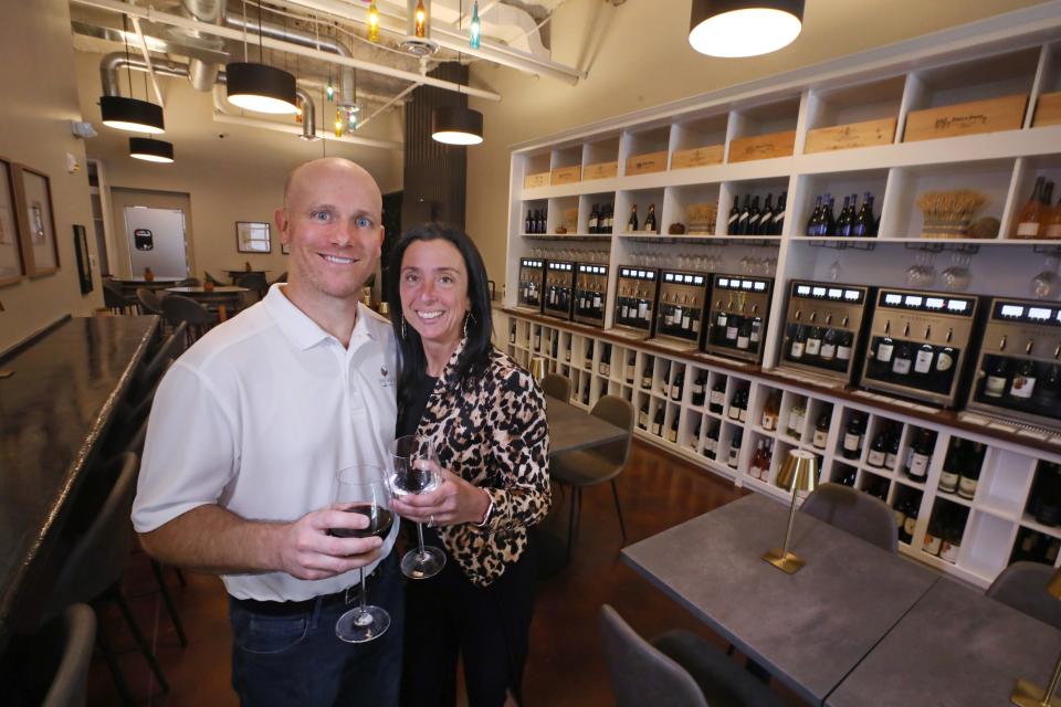 Owners Jim Muir and Paula Miceli raise a toast inside at their new Unwine'd wine bar in downtown Rochester.