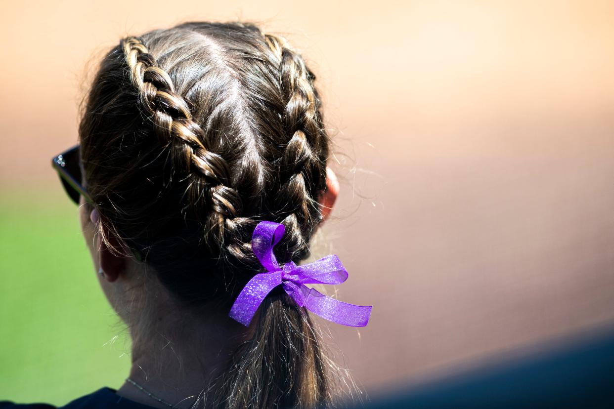A Liberty softball player wears a purple ribbon in her hair during a game against Tennessee on April 27 in Lynchburg, Va. The ribbon is to honor James Madison catcher Lauren Bernett.