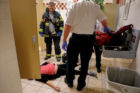 FILE PHOTO: Cataldo Ambulance medics and firefighters revive a woman after overdosing on opioids in Malden