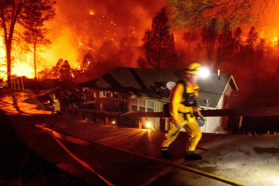 Firefighters protect a home in the Berryessa Estates neighbourhood of Napa County (AP)