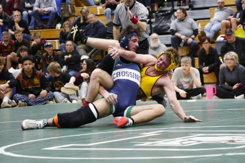 Great Crossing’s Joshua Strayer, left, leaned into Harrison County’s Logan Dingus in their 175 finals match at the Region 6 Championships at Frederick Douglass High School in Lexington on Saturday, Feb. 10, 2024.