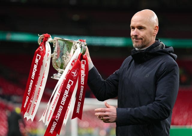 Manchester United manager Erik ten Hag lifts the trophy after winning the Carabao Cup final