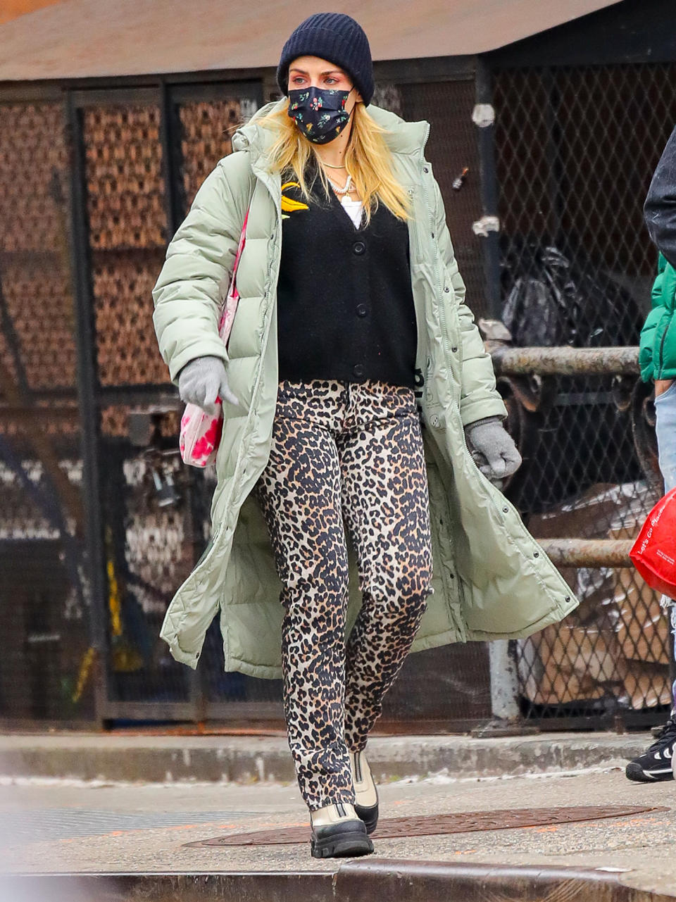 <p>Busy Philipps wears a beanie, a long puffer coat and animal-print pants on Monday in N.Y.C.</p>