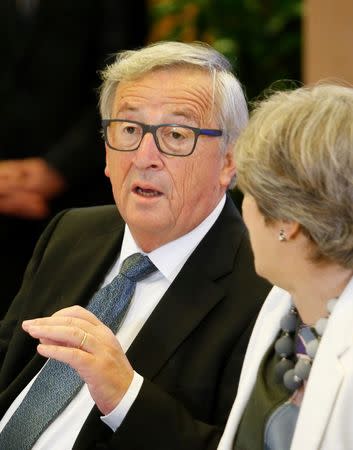 European Commission President Jean-Claude Juncker and British Prime Minister Theresa May take part in an EU summit in Brussels, Belgium October 20, 2017. REUTERS/Julien Warnand/Pool