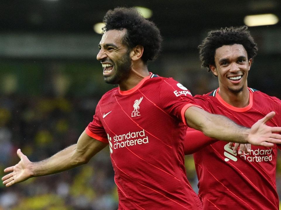 Liverpool's Egyptian midfielder Mohamed Salah (L) celebrates scoring his team's third goal with Liverpool's English defender Trent Alexander-Arnold during the English Premier League football match between Norwich City and Liverpool