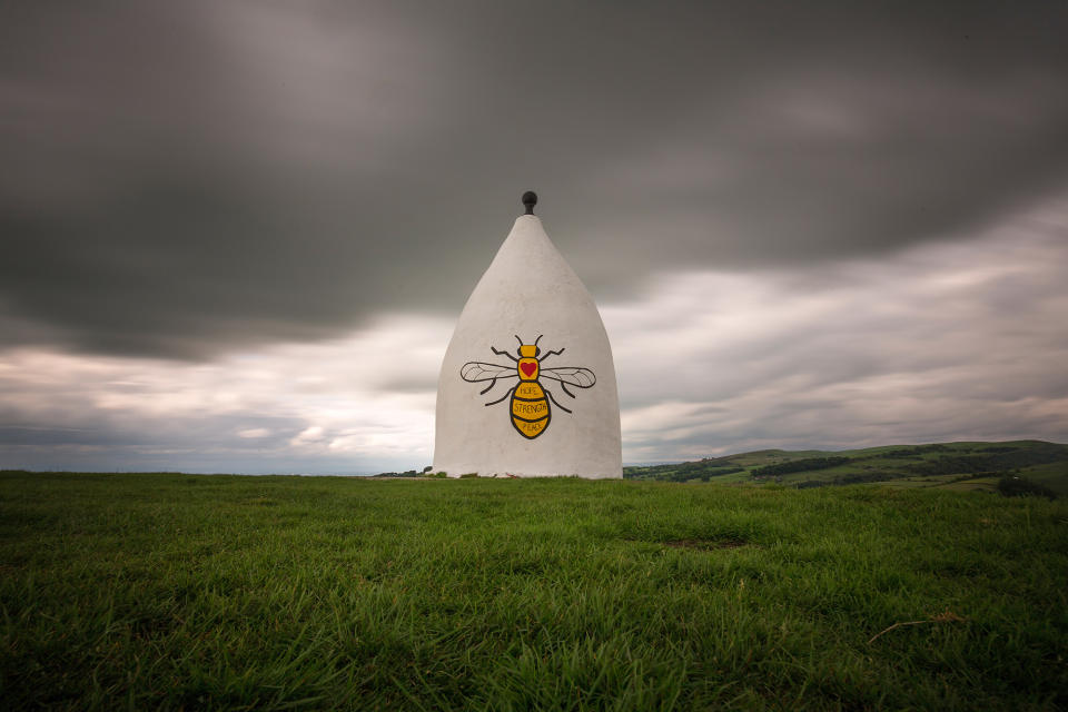 <p>A worker bee adorns the side of Bollington White Nancy to remember those killed and injured in the Manchester Arena attack, on May 30, 2017 in Macclesfield, England. White Nancy overlooks the hills and countryside in East Chesire with views across the plain to Manchester and can be seen for miles. White Nancy was built in 1815 as a summer house, and memorial to the the battle of Waterloo. An explosion occurred at Manchester Arena on the evening of May 22, Killing 22 and injuring many more. (Christopher Furlong/Getty Images) </p>