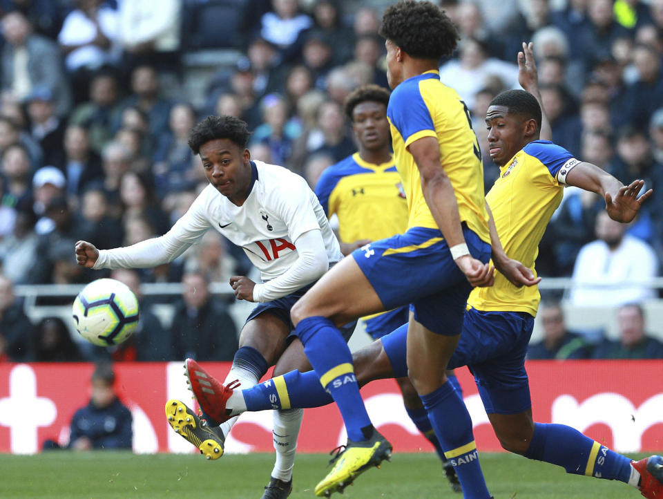 J'Neil Bennett, left, scores his side's first goal of the game against Southampton, during the U18 Premier League test event match at Tottenham Hotspur Stadium in London, Sunday March 24, 2019. Tottenham played Southampton in an Under-18 game in the first official test event at the newly opened 62,000-seater arena, and Spurs winger J'Neil Bennett scored the first-ever goal at the stadium on Sunday. (Ian Walton/PA via AP)