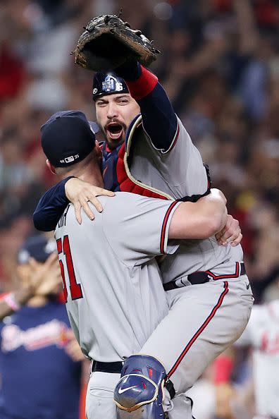 HOUSTON, TEXAS - NOVEMBER 02:  Will Smith #51 and Travis d'Arnaud #16 of the Atlanta Braves celebrate the team's 7-0 victory against the Houston Astros in Game Six to win the 2021 World Series at Minute Maid Park on November 02, 2021 in Houston, Texas. (Photo by Elsa/Getty Images)