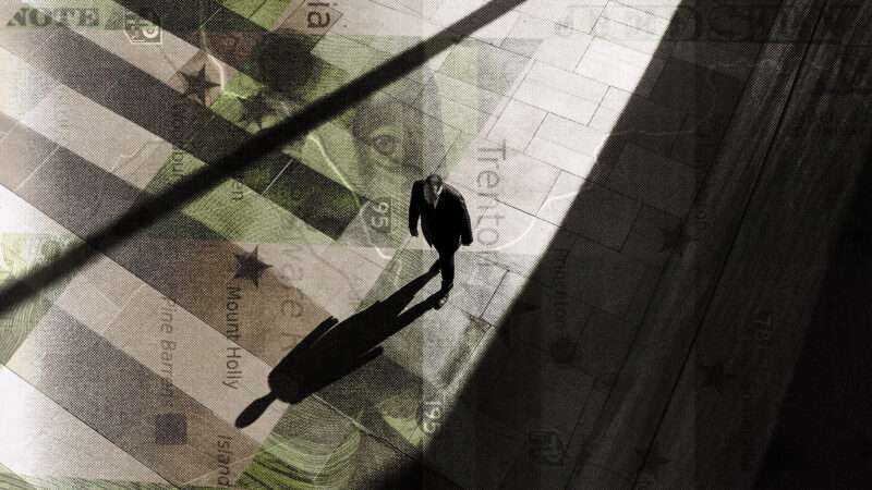 A businessman stands atop a map of Trenton, New Jersey