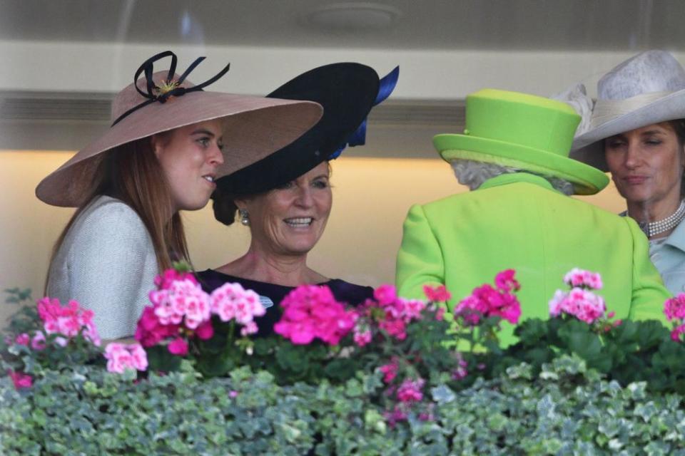 Princess Beatrice (left) and her mom, Sarah Ferguson (center), speak with the Queen at Royal Ascot on June 22, 2018.