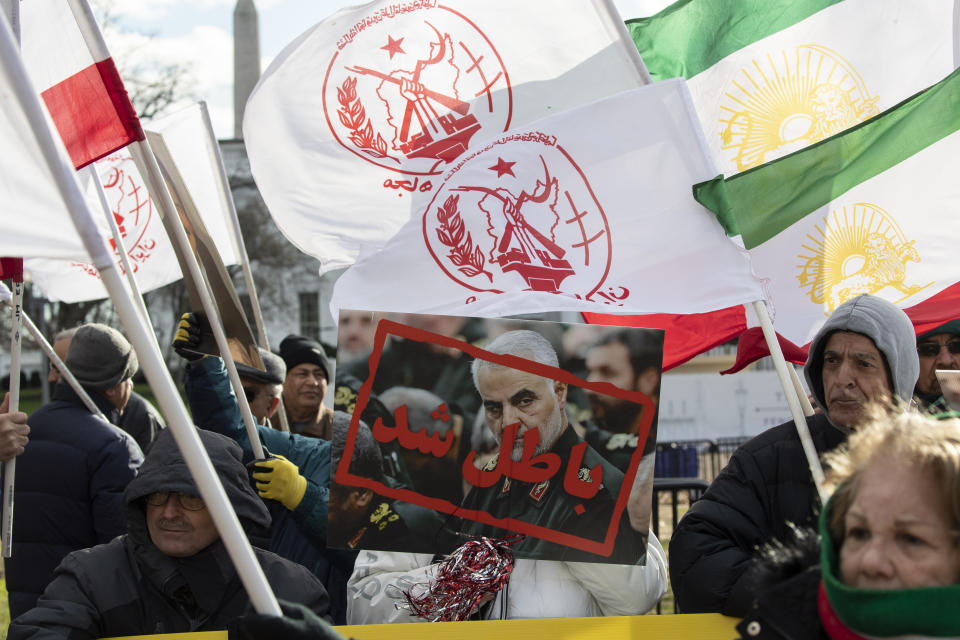 Supporters of the Mujahedeen-e-Khalq, or the MEK, an Iranian exile group, hold signs and flags during a show of support for a U.S. airstrike in Iraq that killed Iranian Gen. Qassem Soleimani, in Lafayette Park across from the White House, Sunday, Jan. 5, 2020, in Washington. (AP Photo/Alex Brandon)