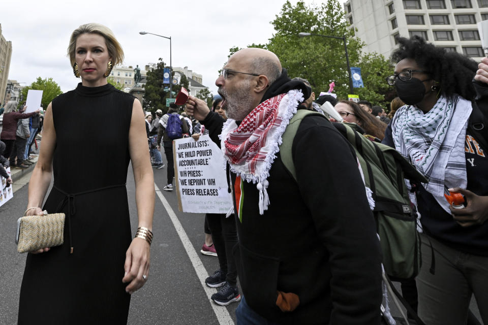 A White House Correspondents' Association Dinner attendee, left, is confronted by a demonstrator during a pro-Palestinian protest over the Israel-Hamas war