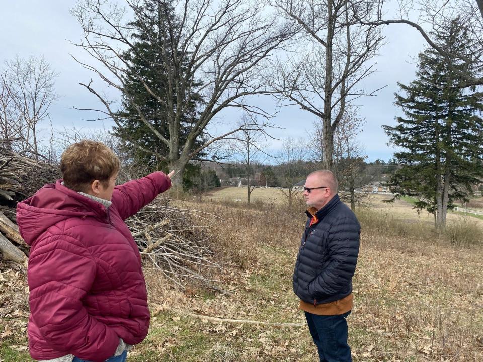 Angela Eisaman, left, board president of Taking Root Farms, points where the new day-habilitation facility for adults with developmental disabilities will be constructed on the property of Raemelton Therapeutic Equestrian Center, 569 S. Trimble Road.