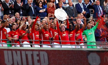 Football Soccer Britain - Leicester City v Manchester United - FA Community Shield - Wembley Stadium - 7/8/16 Manchester United's Wayne Rooney celebrates with the trophy after winning the FA Community Shield Reuters / Eddie Keogh