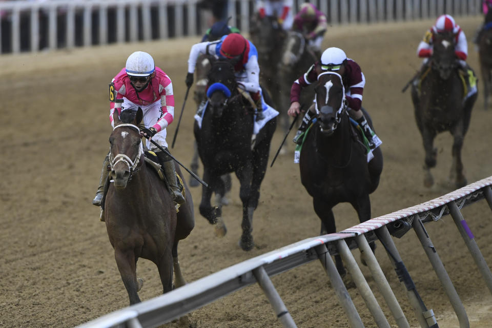 Flavien Prat atop Rombauer, left, wins the 146th Preakness Stakes horse race at Pimlico Race Course, Saturday, May 15, 2021, in Baltimore. (AP Photo/Will Newton)