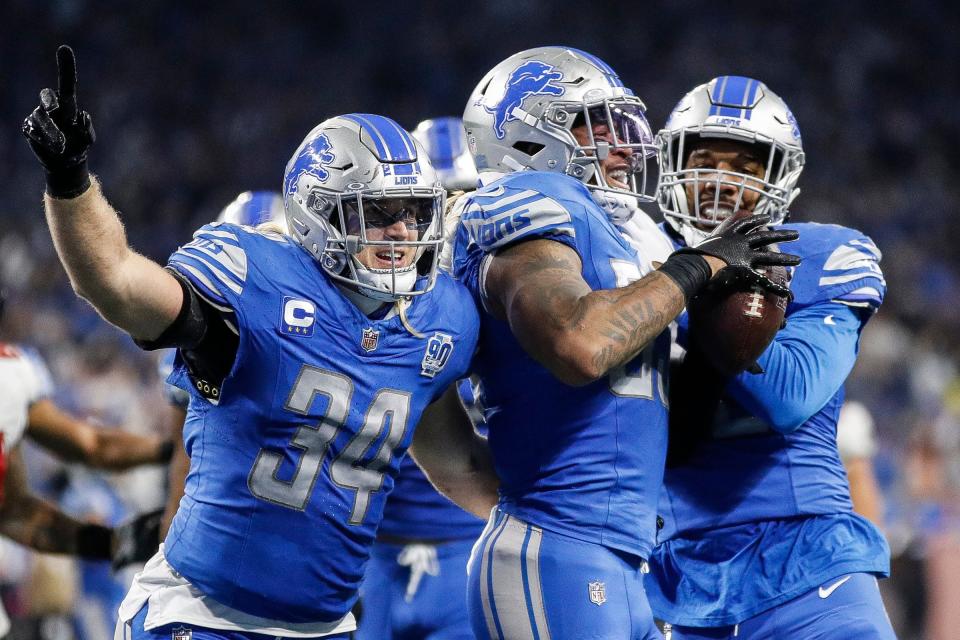 Detroit Lions linebacker Derrick Barnes (55) celebrates an interception from Tampa Bay Buccaneers quarterback Baker Mayfield with linebacker Alex Anzalone (34) and linebacker Jalen Reeves-Maybin (42) during the second half of the NFC divisional round at Ford Field in Detroit on Sunday, Jan. 21, 2024.