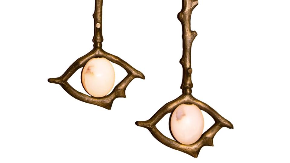 long pendants lights with a stem that looks like a thin tree branch with stumps and an eye at the bottom