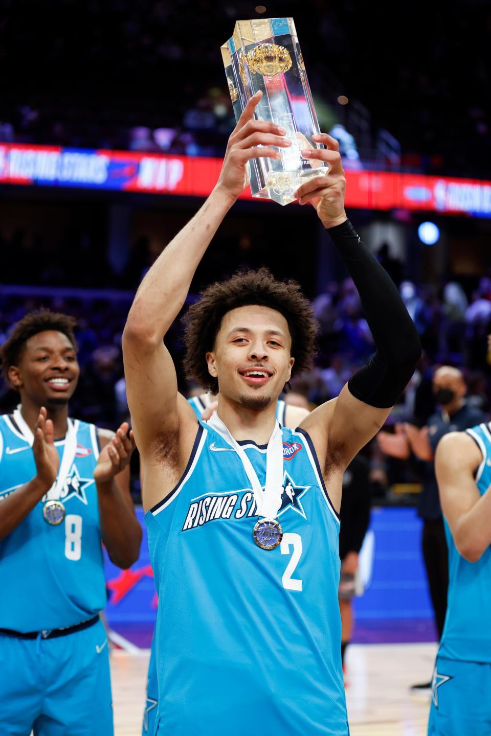 Team Barry's Cade Cunningham, of the Detroit Pistons, holds the trophy after being named the MVP of the NBA basketball Rising Stars event, Friday, Feb. 18, 2022, in Cleveland. Team Barry defeated Team Isiah to win the event.