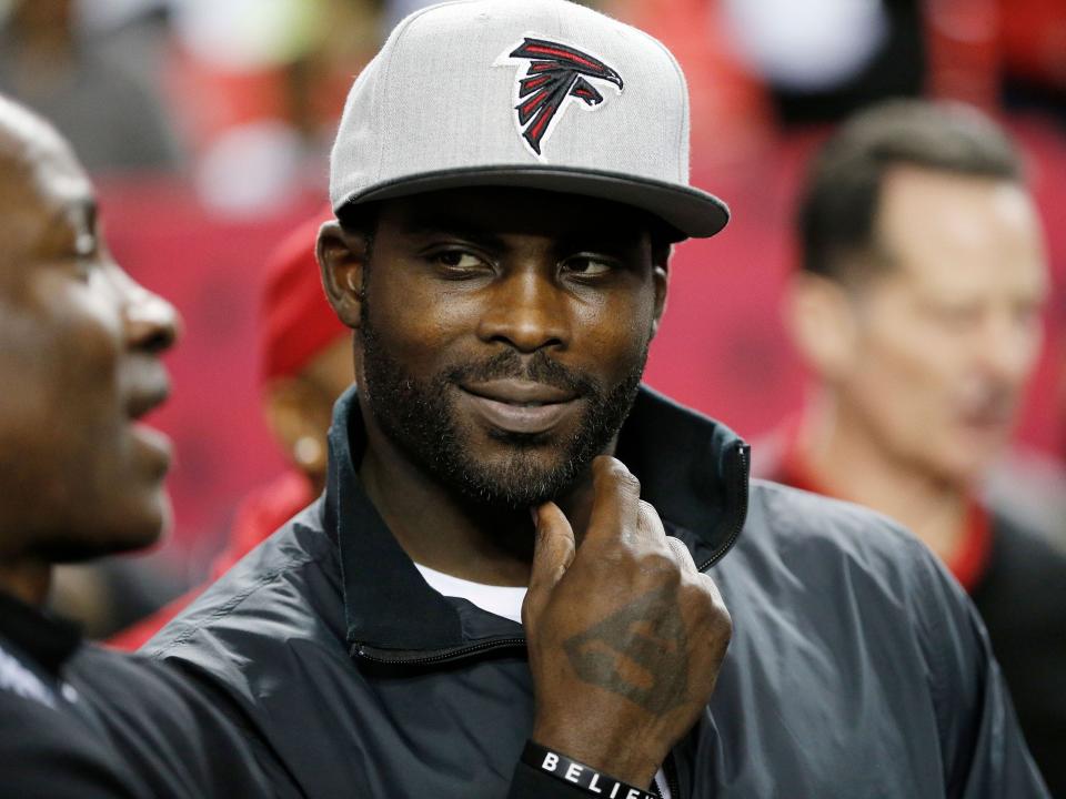 Michael Vick stands on the sidelines during a game against the New Orleans Saints.