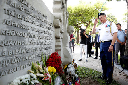 Military Attache Ton Tuan from U.S. Embassy salutes while he pays respect in memory of the late U.S. Senator John McCain (R-AZ) at the McCain Memorial in Hanoi, Vietnam August 27, 2018. REUTERS/Kham