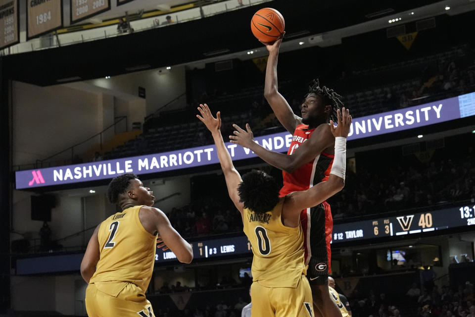 Georgia forward Dylan James (13) shoots over Vanderbilt guard Tyrin Lawrence (0) and forward Ven-Allen Lubin (2) during the second half of an NCAA college basketball game Wednesday, Feb. 21, 2024, in Nashville, Tenn. (AP Photo/George Walker IV)