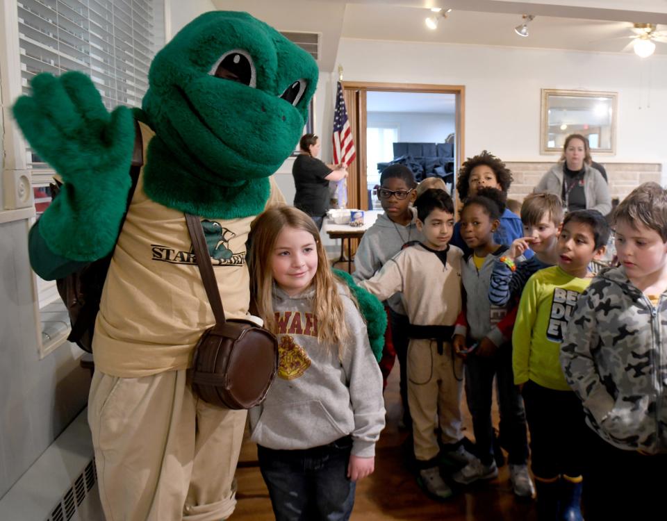 Summit Arts Academy second grade student Amelia Rowland gets a hug from surprise visitor FeLeap the Frog from Stark Parks who stopped by Canton's 10th annual Arbor Day Celebration at Canton Garden Center. The event was present by Canton City, the Canton Tree Commission and Canton Parks & Recreation.