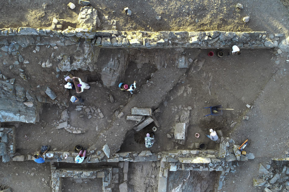 In this photo released by the Greek Culture Ministry on Wednesday, June 7, 2023. excavation staff work on the remains of an ancient sanctuary on the Aegean Sea island of Kythnos. Archaeologists excavating a hilltop sanctuary on the Aegean Sea island of Kythnos have discovered “countless” pottery offerings left there by ancient worshippers over the centuries, Greece's Culture Ministry said Wednesday Several ceremonial pottery vessels were also unearthed which are linked with the worship of Demeter, the ancient Greek goddess of agriculture, and her daughter Persephone, to which the building complex was dedicated. (Alexandros Mazarakis Ainian/Greek Culture Ministry via AP)