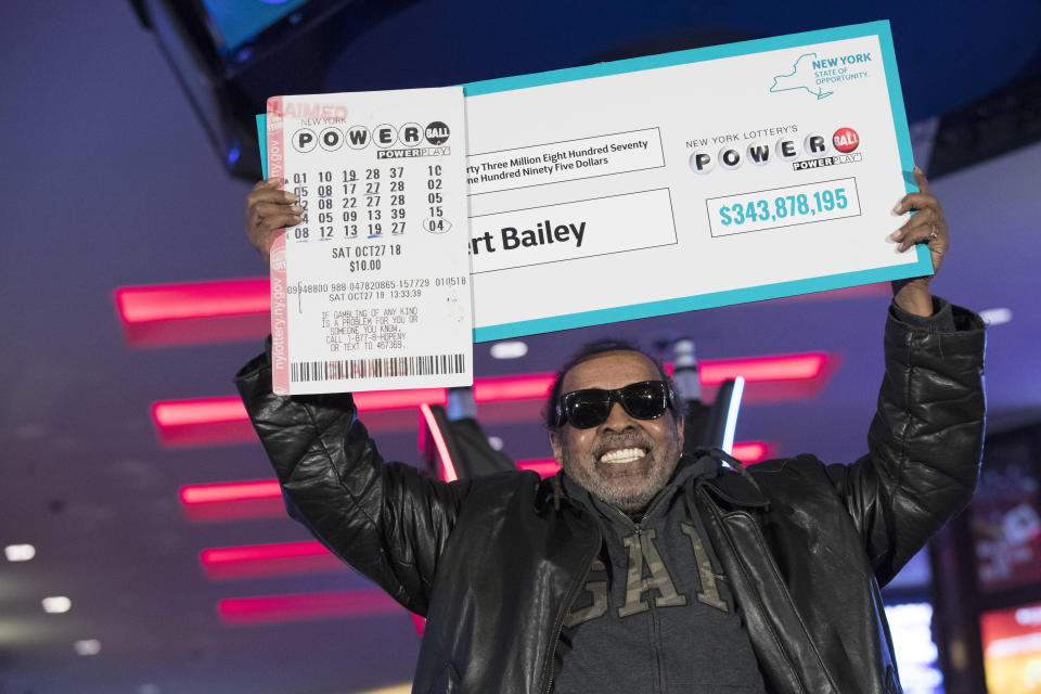 Robert Bailey poses for photographers during a news conference at the Resorts World Casino New York City, Wednesday, Nov. 14, 2018, in New York. The retired government worker won over $343 million in Powerball, the biggest jackpot in New York state lottery history. (AP Photo/Mary Altaffer)