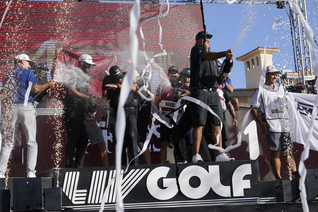 Pat Perez, front right, and Dustin Johnson, second from left, celebrate after the 4 Aces GC team won the LIV Golf Team Championship at Trump National Doral Golf Club, Sunday, Oct. 30, 2022, in Doral, Fla. (AP Photo/Lynne Sladky)