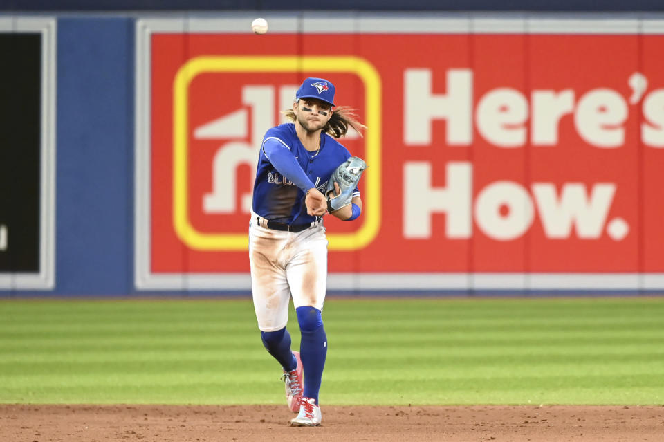 Toronto Blue Jays shortstop Bo Bichette throws to first base to put out Boston Red Sox's Rob Refsnyder in the sixth inning of a baseball game in Toronto, Monday June 27, 2022. (Jon Blacker/The Canadian Press via AP)