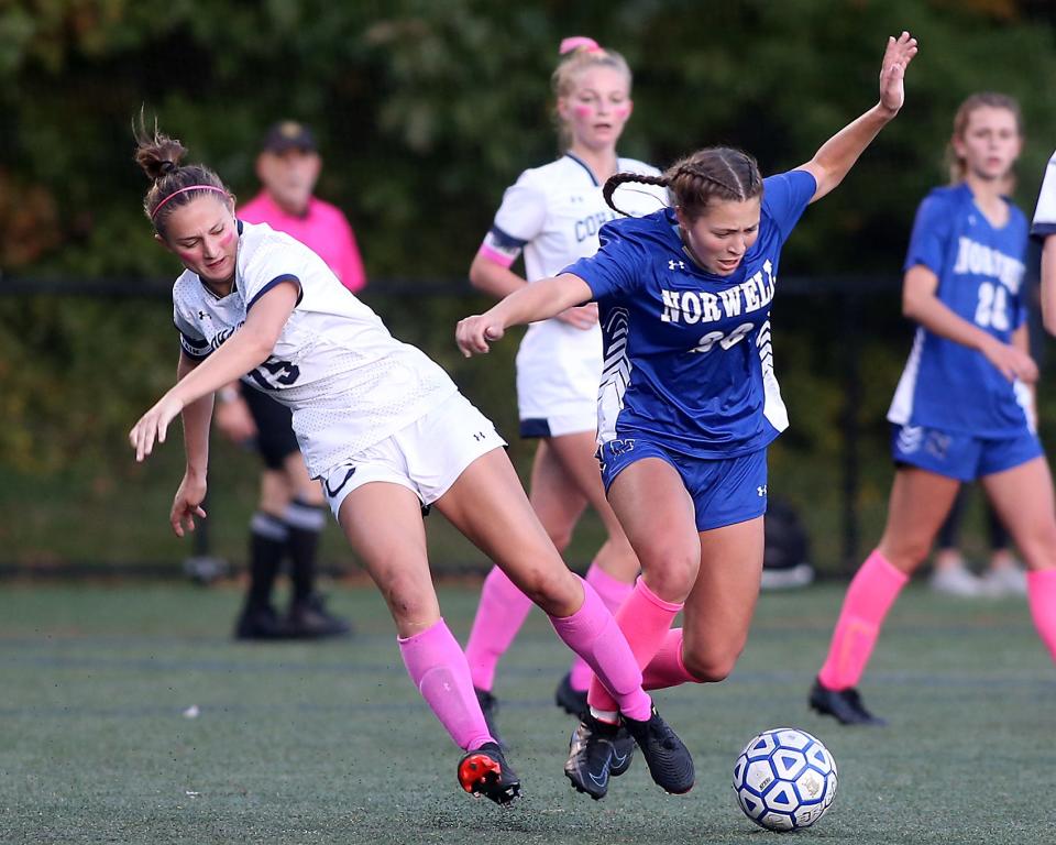 Cohasset's Cat Herman trips up Norwell's Chloe Kirchner earning a free kick during second half action of their game against Cohasset at the Norwell Clipper Community Complex on Tuesday, Oct. 11, 2022.