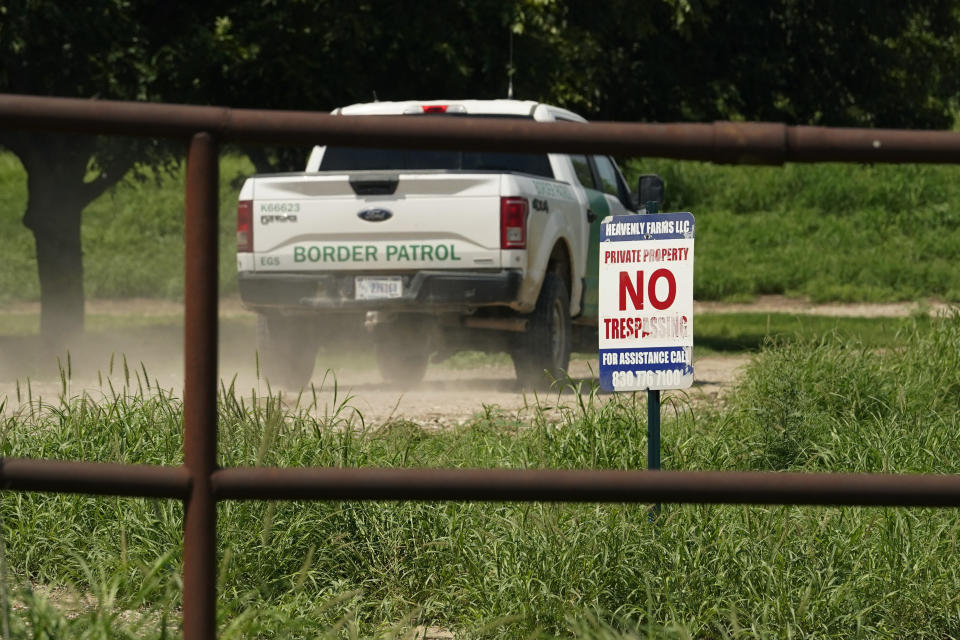A Border Patrol vehicle enters Heavenly Farms, a pecan farm owned by Hugo and Magali Urbina, Friday, Aug. 26, 2022, in Eagle Pass, Texas. The area has become entangled in a turf war between the Biden administration and Texas Gov. Greg Abbott over how to police the U.S. border with Mexico. (AP Photo/Eric Gay)