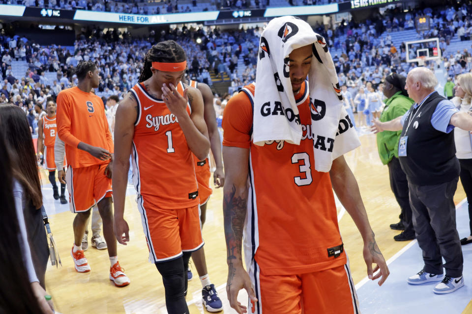 Syracuse forward Maliq Brown (1) and guard Judah Mintz (3) leave the floor after falling to North Carolina in an NCAA college basketball game Saturday, Jan. 13, 2024, in Chapel Hill, N.C. (AP Photo/Chris Seward)