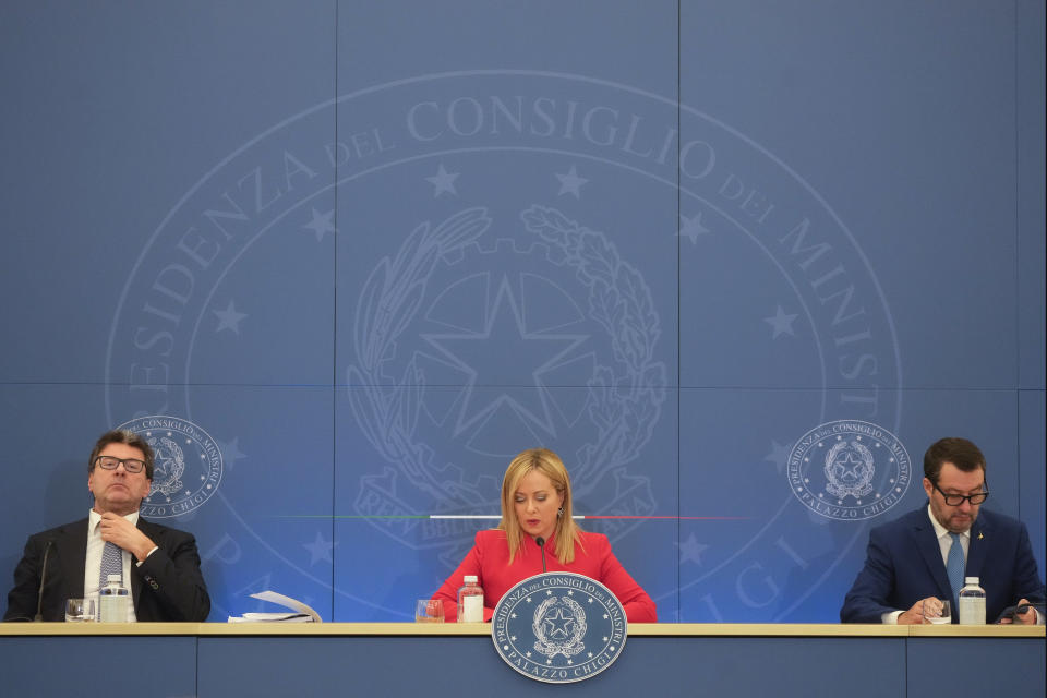 Italian Premier Giorgia Meloni, center, Finance Minister Giancarlo Giorgetti, left, and Deputy Prime Minister and Minister of Infrastructure and Sustainable Mobility Matteo Salvini arrive at a press conference to present the 2023 proposed budget in Rome, Tuesday, Nov. 22, 2022. (AP Photo/Gregorio Borgia)