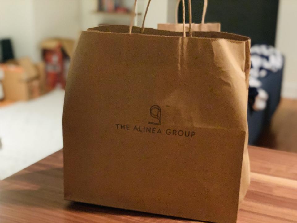 Brown bag with the food inside from Alinea