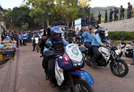 Police officers driving motorcycles are seen outside the headquarters of Honduras' elite police force, after an agreement with the government not to crack down on demonstratrators in the marches over a contested presidential election, according to local media, in Tegucigalpa, Honduras December 5, 2017. REUTERS/Henry Romero