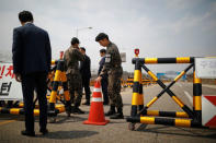 South Korean soldiers and security personnel stand guard at a checkpoint on the Grand Unification Bridge that leads to the Peace House, the venue for the Inter-Korean summit, near the demilitarized zone separating the two Koreas, in Paju, South Korea, April 26, 2018. REUTERS/Kim Hong-Ji
