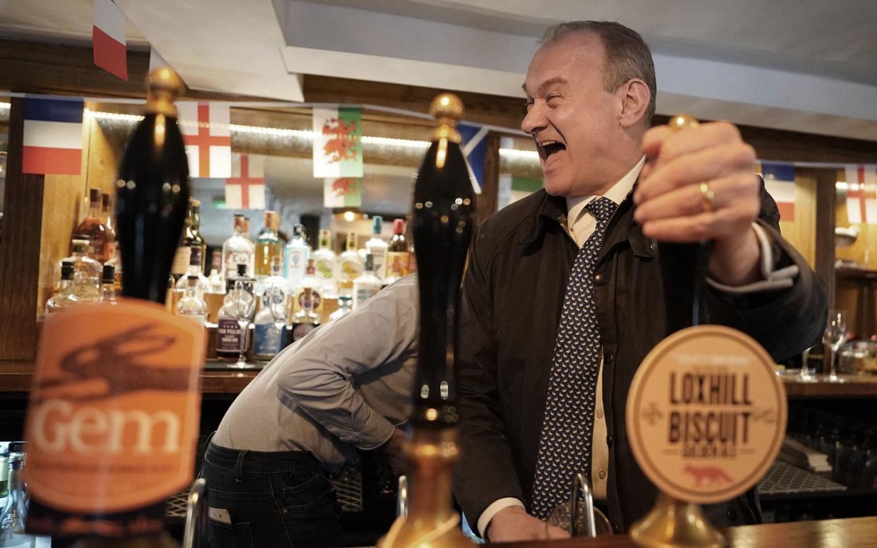 Sir Ed Davey, the leader of the Liberal Democrats, is pictured today pulling a pint in The Star in Witley, Surrey, during his visit to the Godalming and Ash constituency of Jeremy Hunt