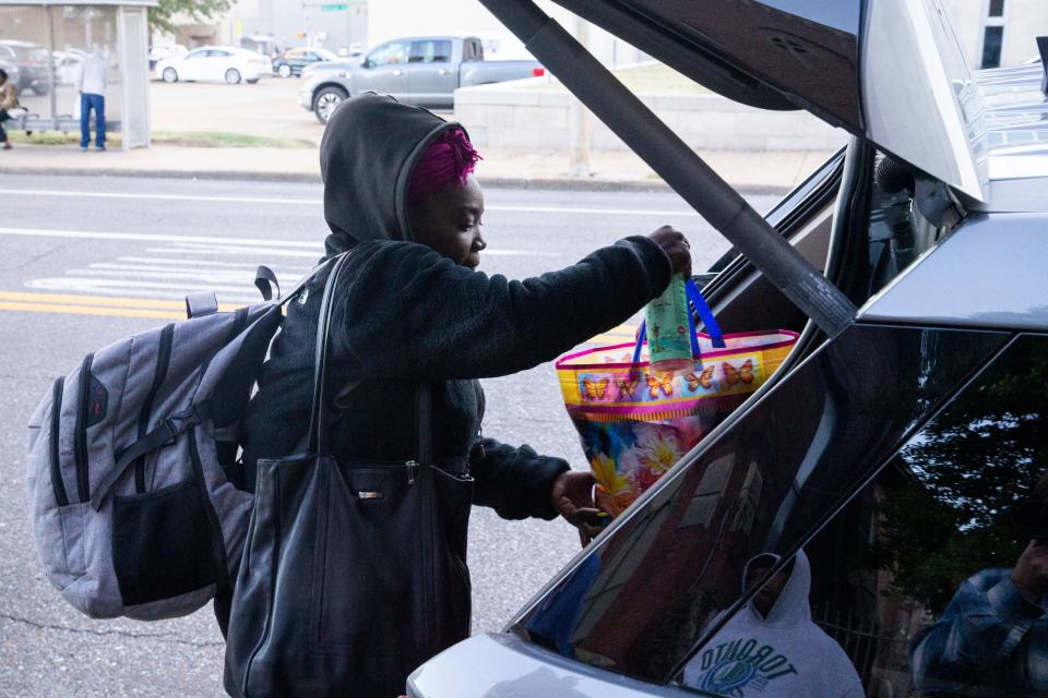 Chanel loads her belongings into the vehicle of a volunteer from St. Louis Catholic Church who would transport her to Christ the King Lutheran Church in East Memphis to spend the night there through the Room In The Inn program in Memphis, Tenn., on Wednesday, November 1, 2023.