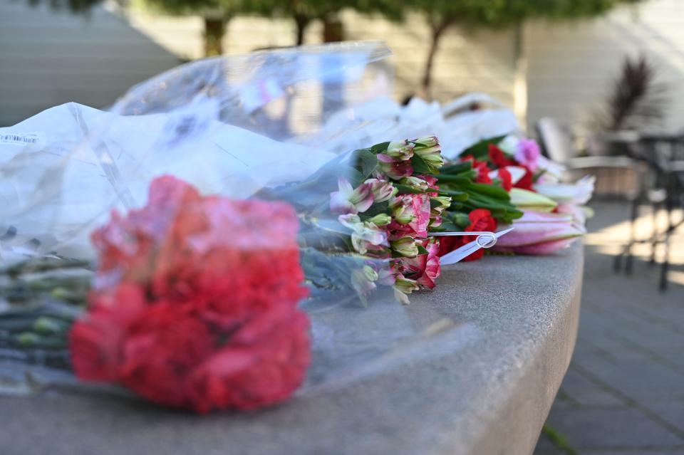 A row of bouquets was placed across the street from the Half Moon Bay city hall in honor of the shooting victims in Half Moon Bay, Calif., on Jan. 24.