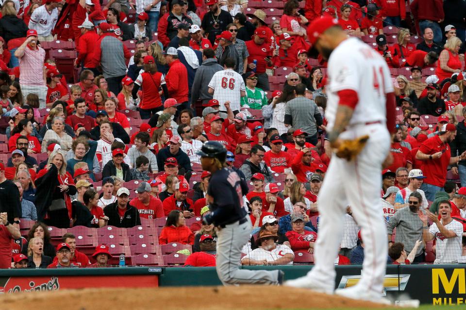 Fans head for the exit as Cleveland Guardians third baseman Jose Ramirez (11) runs the bases on a grand slam in the ninth inning of the MLB Inter-league game between the Cincinnati Reds and the Cleveland Guardians at Great American Ball Park in downtown Cincinnati on Tuesday, April 12, 2022. The Guardians won 10-5 in the Reds home-opening game. 